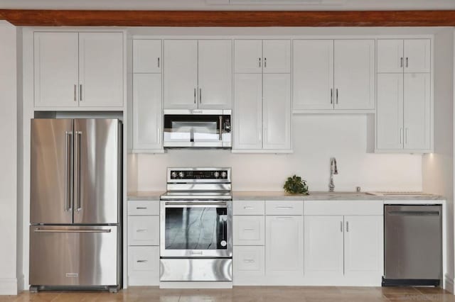 kitchen featuring white cabinetry, appliances with stainless steel finishes, and sink