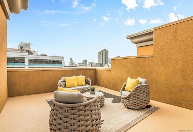 view of patio with outdoor lounge area and a balcony