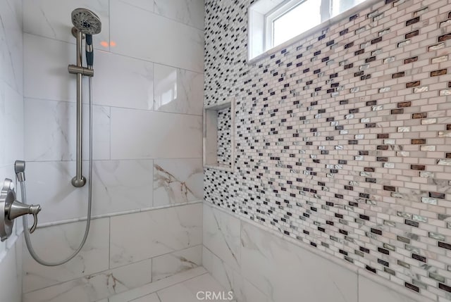 bathroom with tiled shower