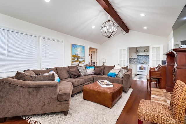 living room featuring lofted ceiling with beams, light hardwood / wood-style flooring, and a notable chandelier