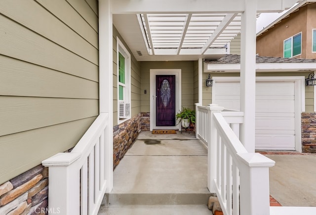 view of exterior entry with a garage