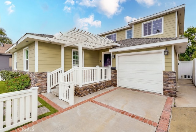 view of front of house with a garage and a pergola