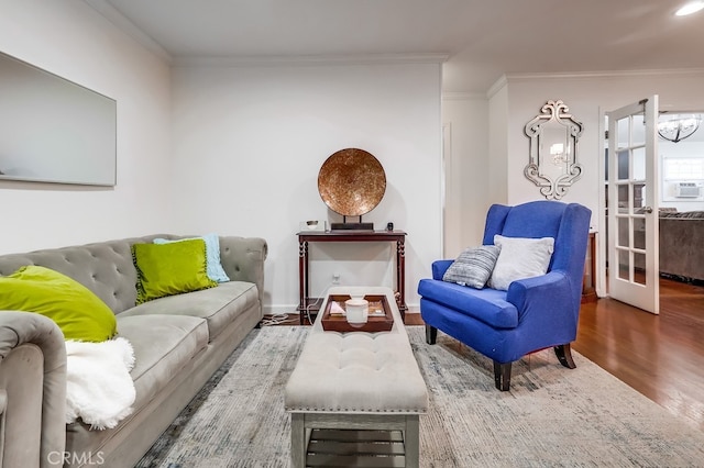 living room with crown molding, french doors, and hardwood / wood-style flooring