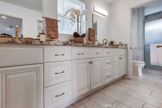 bathroom featuring vanity and toilet