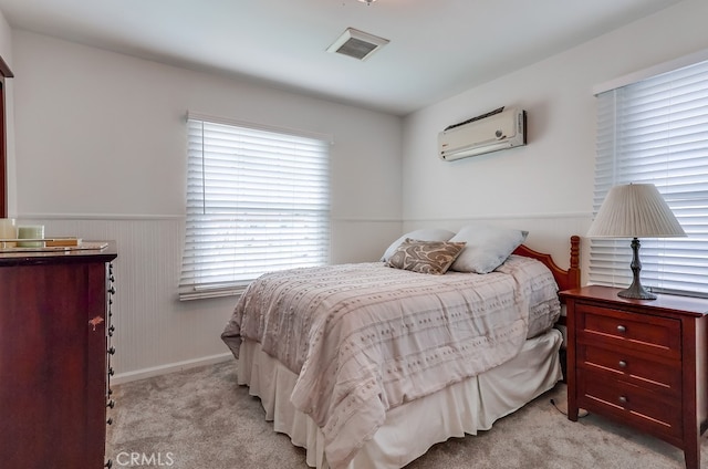 carpeted bedroom with a wall mounted AC