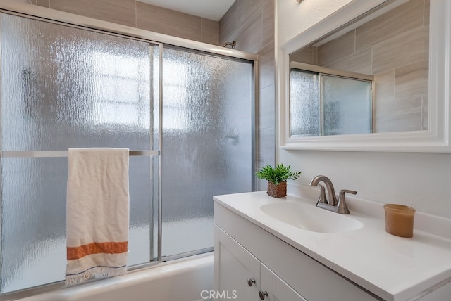 bathroom featuring vanity and combined bath / shower with glass door