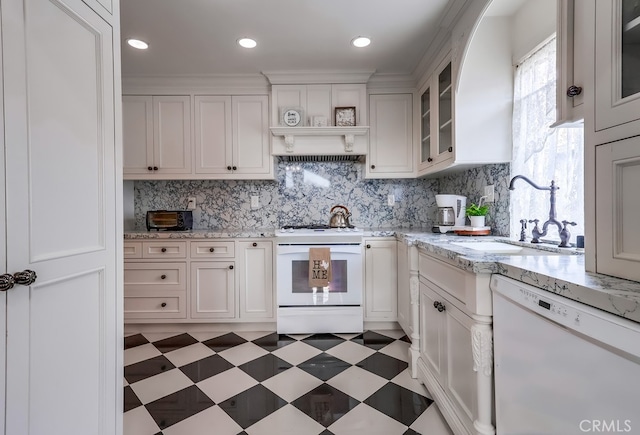 kitchen with white cabinetry, sink, and white appliances