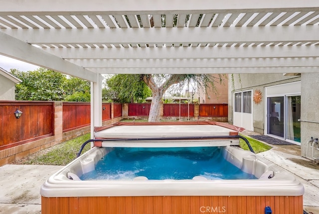 view of swimming pool featuring a hot tub