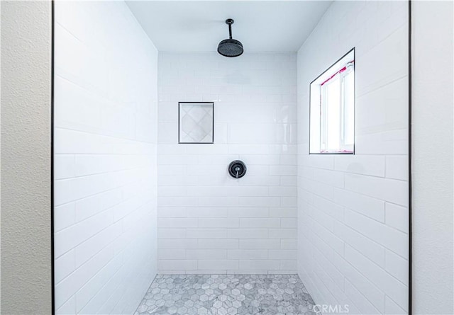 full bath featuring tiled shower