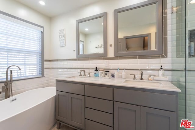 bathroom featuring vanity, tile walls, and plus walk in shower