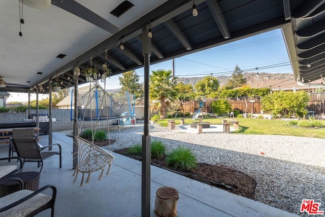 view of patio with a playground and a trampoline