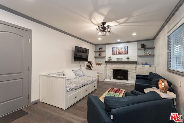 living room with crown molding, a stone fireplace, and dark wood-type flooring