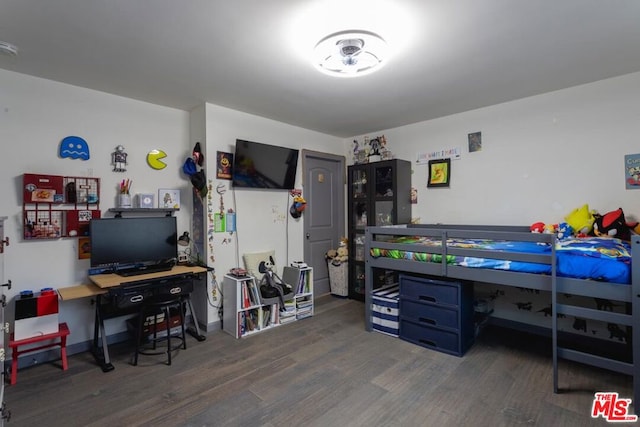 bedroom with dark wood-type flooring