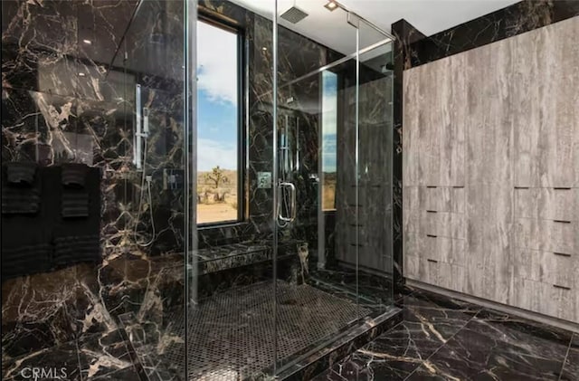 bathroom featuring a shower with shower door