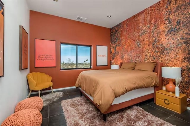 bedroom with dark tile patterned floors