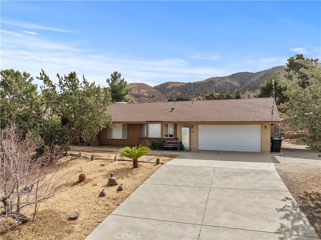 single story home featuring a garage and a mountain view