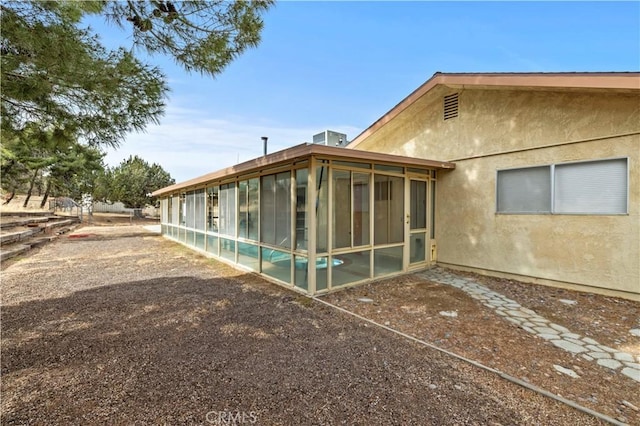 rear view of property with a sunroom