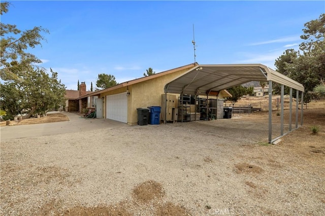 view of parking / parking lot with a garage and a carport