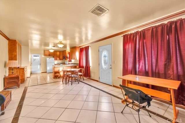 tiled entrance foyer featuring ornamental molding