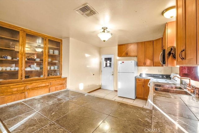 kitchen with sink and white fridge