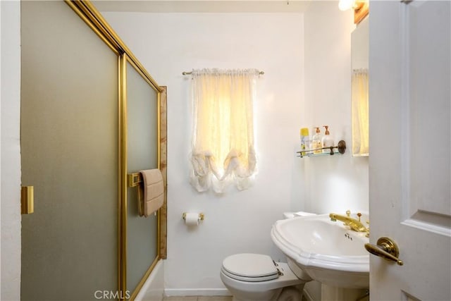 full bathroom with toilet, sink, and combined bath / shower with glass door