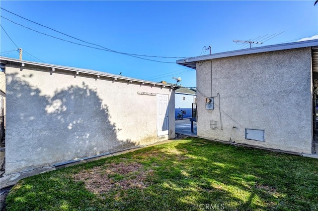 view of side of property with a yard