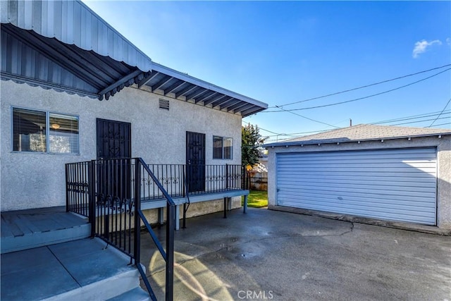 exterior space with an outbuilding and a garage