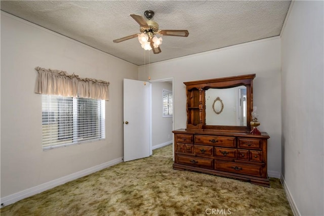 bedroom with ceiling fan, carpet, and a textured ceiling