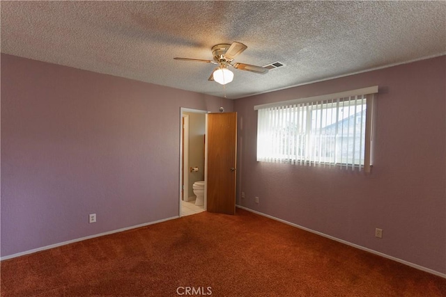 empty room featuring baseboards, carpet, visible vents, and a ceiling fan