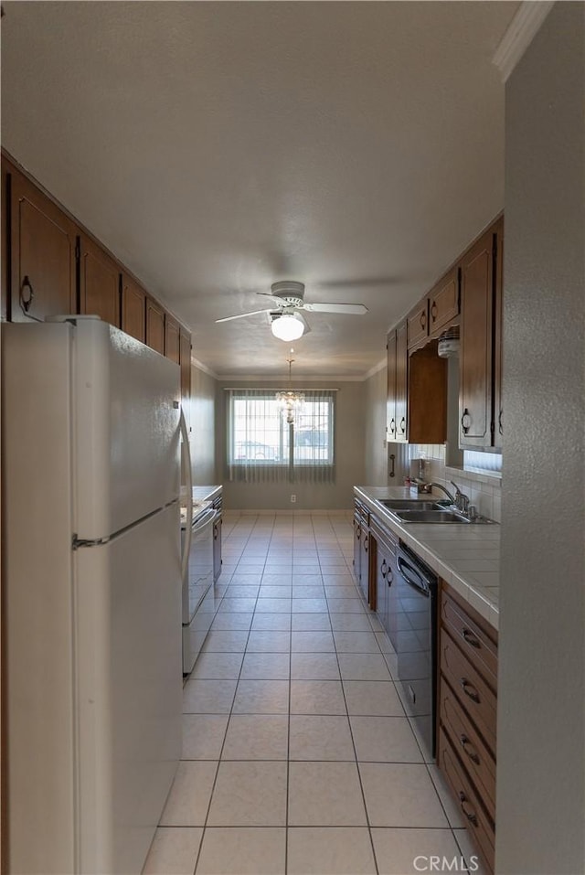 kitchen featuring white appliances, brown cabinetry, light tile patterned flooring, and tile counters