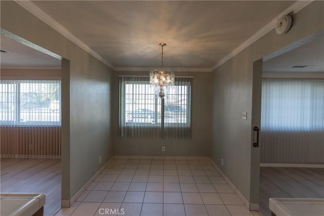 unfurnished dining area featuring ornamental molding, light tile patterned flooring, a notable chandelier, and baseboards