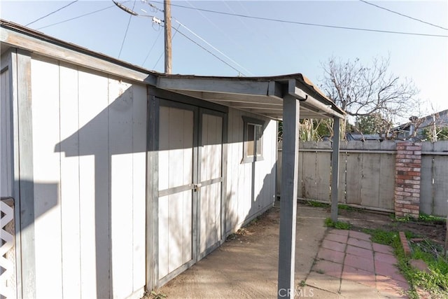 view of side of home featuring fence