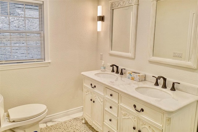 bathroom featuring tile patterned flooring, vanity, and toilet