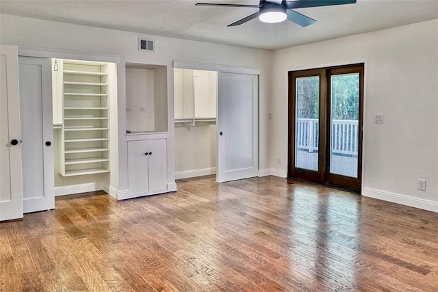 unfurnished bedroom with access to exterior, hardwood / wood-style floors, and ceiling fan