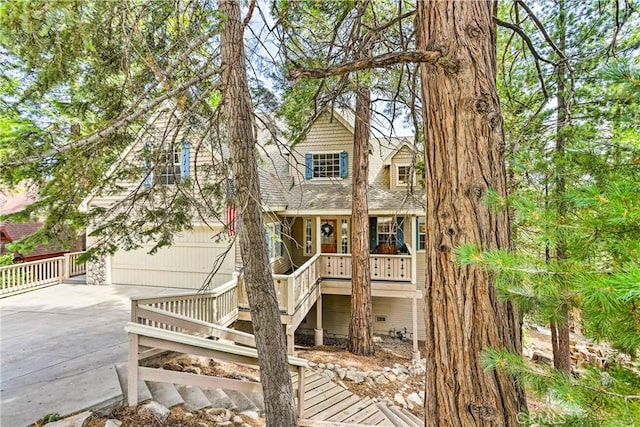 view of front of house featuring a porch and a garage