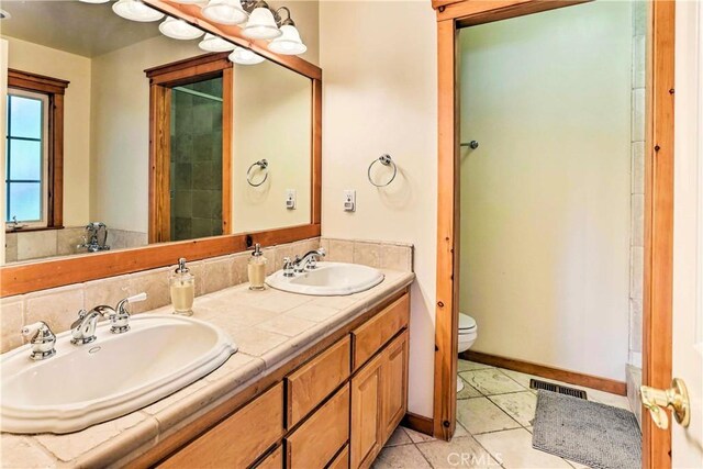 bathroom with vanity, tile patterned floors, and toilet