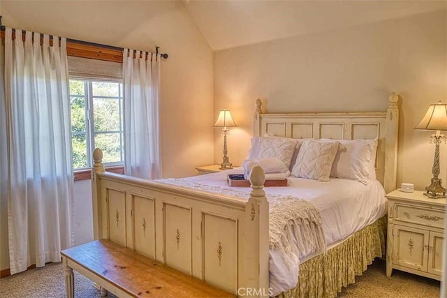 carpeted bedroom featuring vaulted ceiling