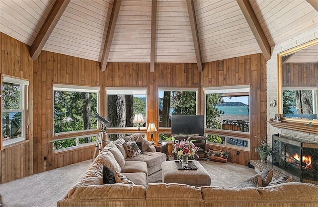 sunroom / solarium featuring a fireplace and lofted ceiling with beams