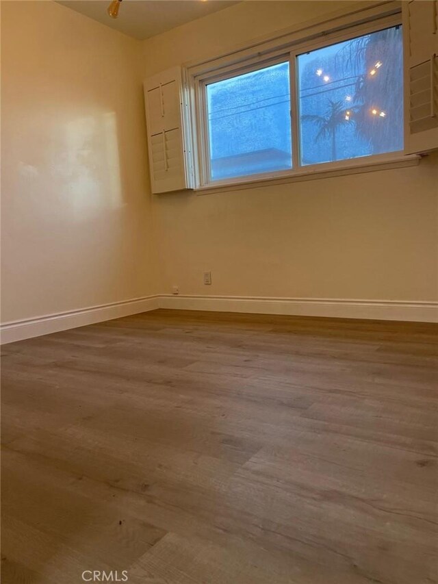 unfurnished room with hardwood / wood-style floors