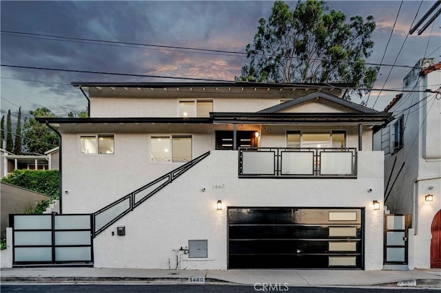 view of front of property with a garage and a balcony