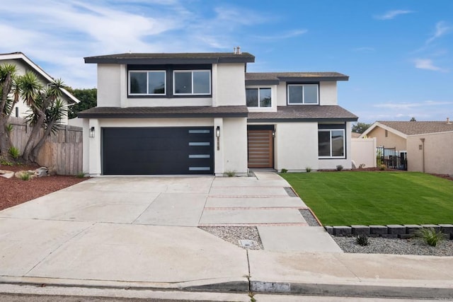 view of front of home with a garage and a front yard