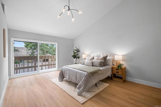 bedroom with high vaulted ceiling, a notable chandelier, and light hardwood / wood-style floors