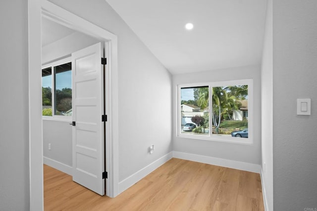 interior space featuring vaulted ceiling and light wood-type flooring