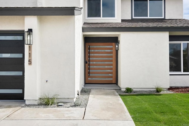 doorway to property featuring a lawn