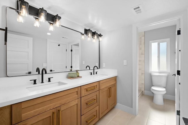 bathroom with tile patterned flooring, vanity, walk in shower, and toilet