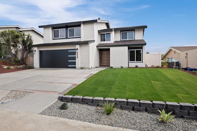 view of front of home featuring a garage and a front yard