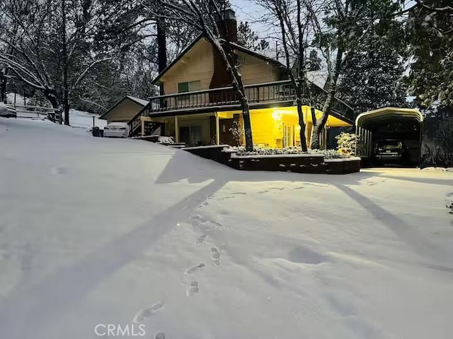 view of front of property featuring a carport and a deck