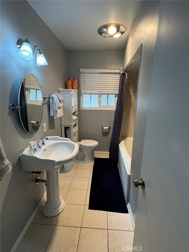 bathroom with tile patterned flooring, shower / tub combo, and toilet