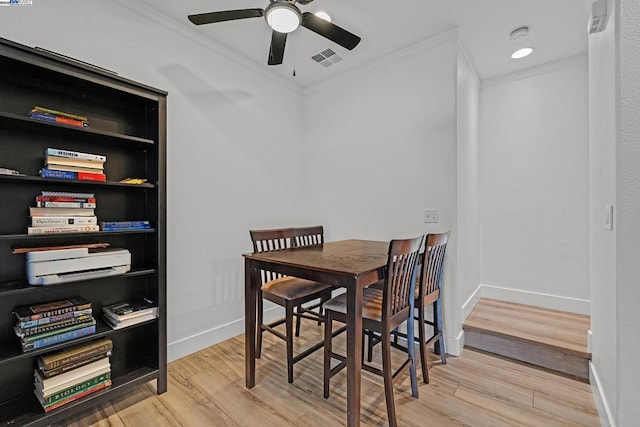 dining room featuring crown molding, ceiling fan, and light hardwood / wood-style flooring