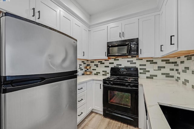 kitchen with backsplash, white cabinets, light stone countertops, and black appliances